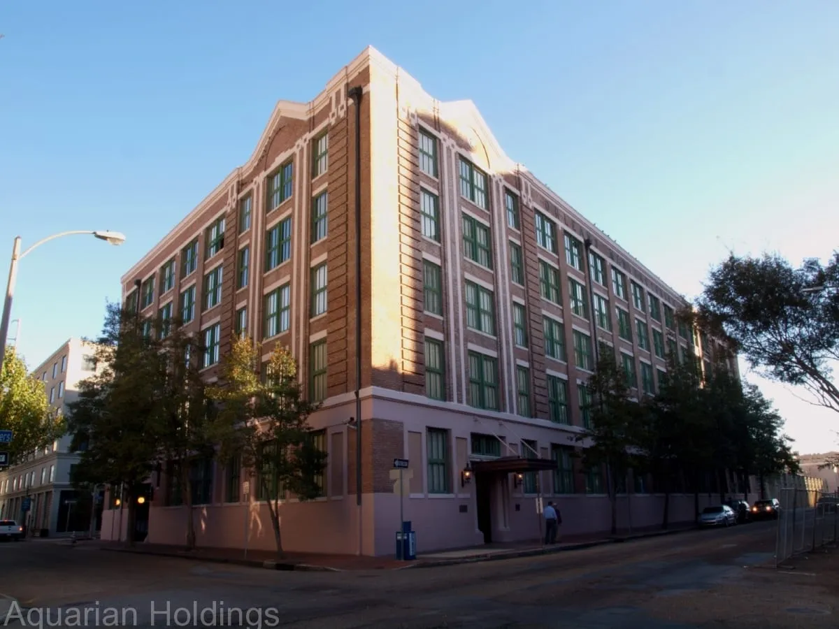 The 700 South Peters building, a renovated brick warehouse condo building at dusk