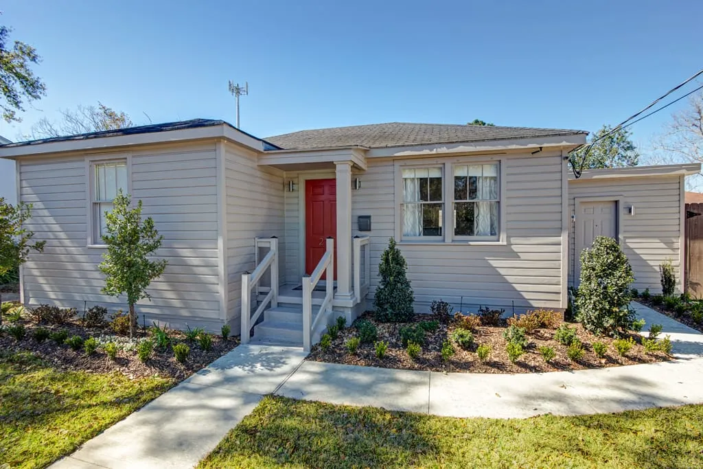 Front of the cottage with red door and new plantings