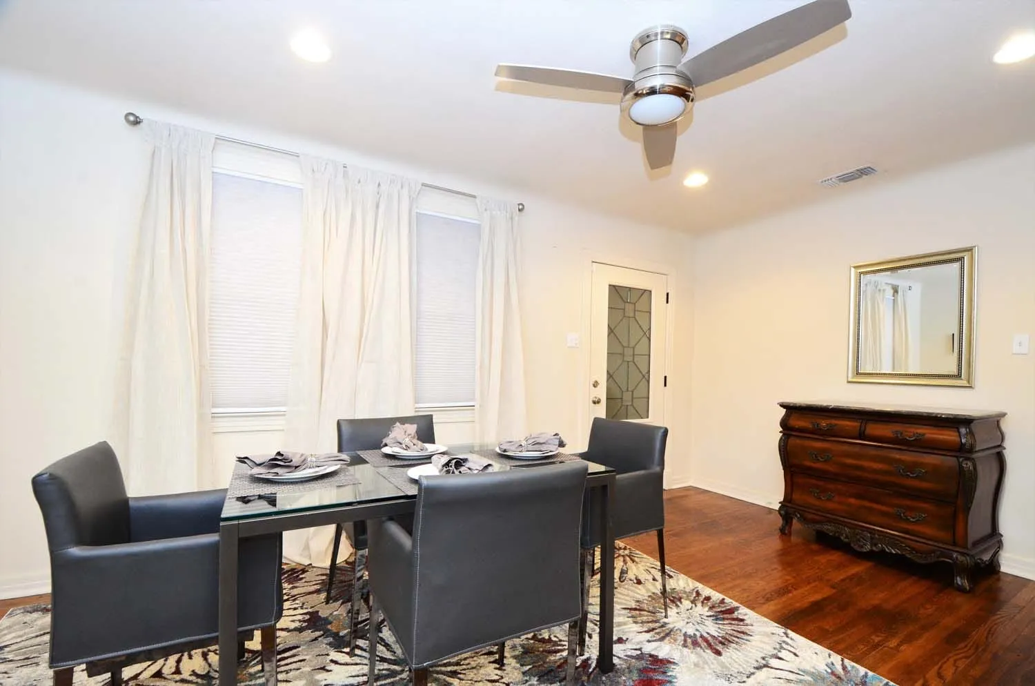 Dining room with table for four and ceiling fan