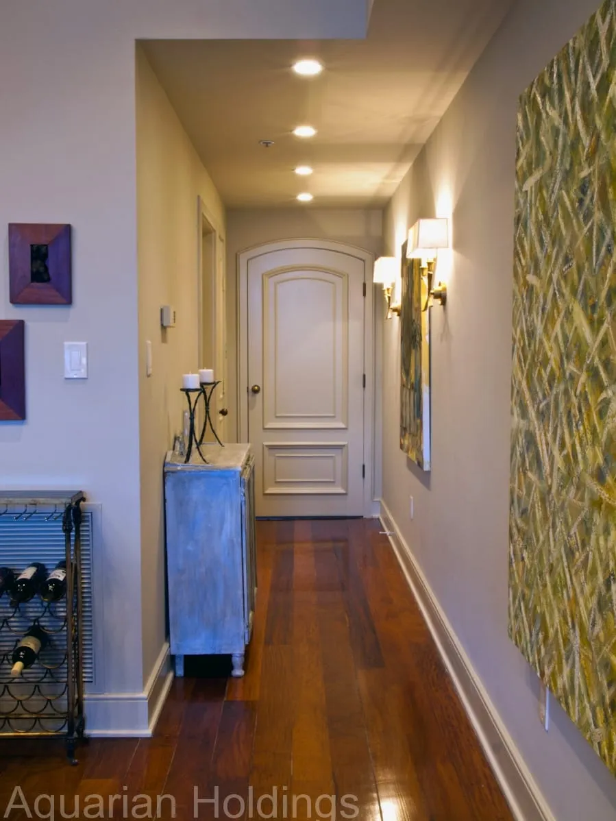 Condo entry hall with wood floors and artwork