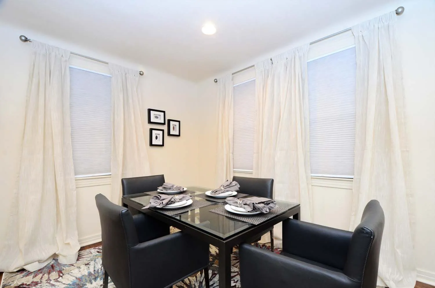 Dining nook with curtained windows