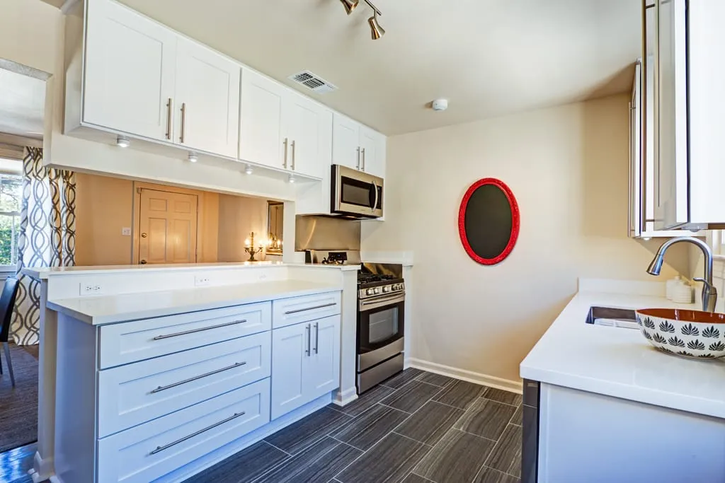 White kitchen with gas range and microwave