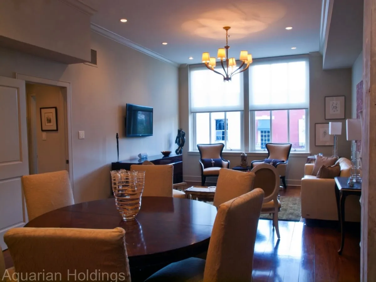 Open living and dining area with large windows and high ceilings