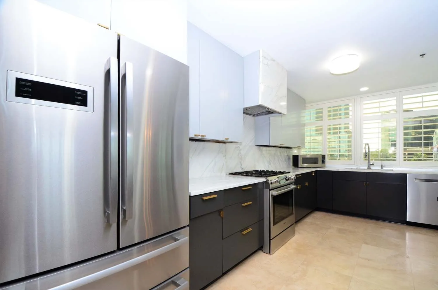 Kitchen with stainless refrigerator and dark cabinetry