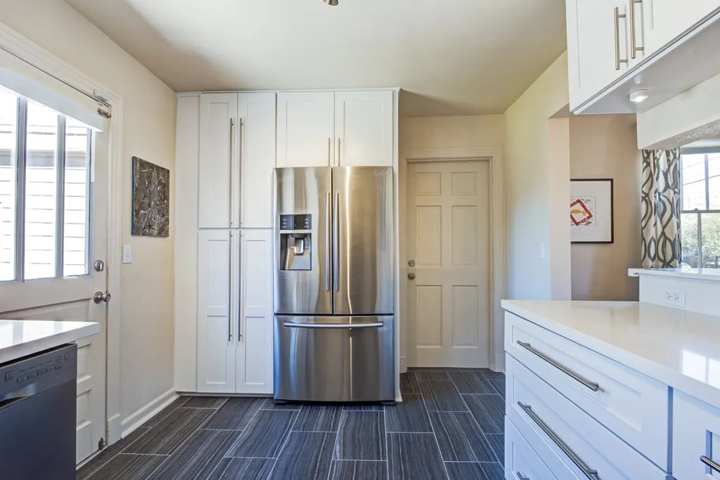 Kitchen with stainless refrigerator and dishwasher