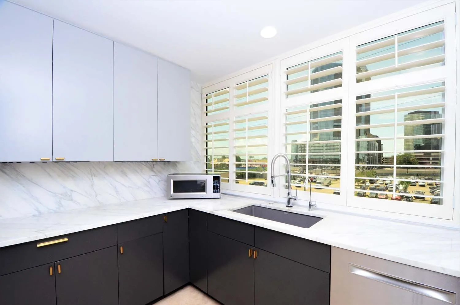 Kitchen counters lit by plantation-shuttered windows