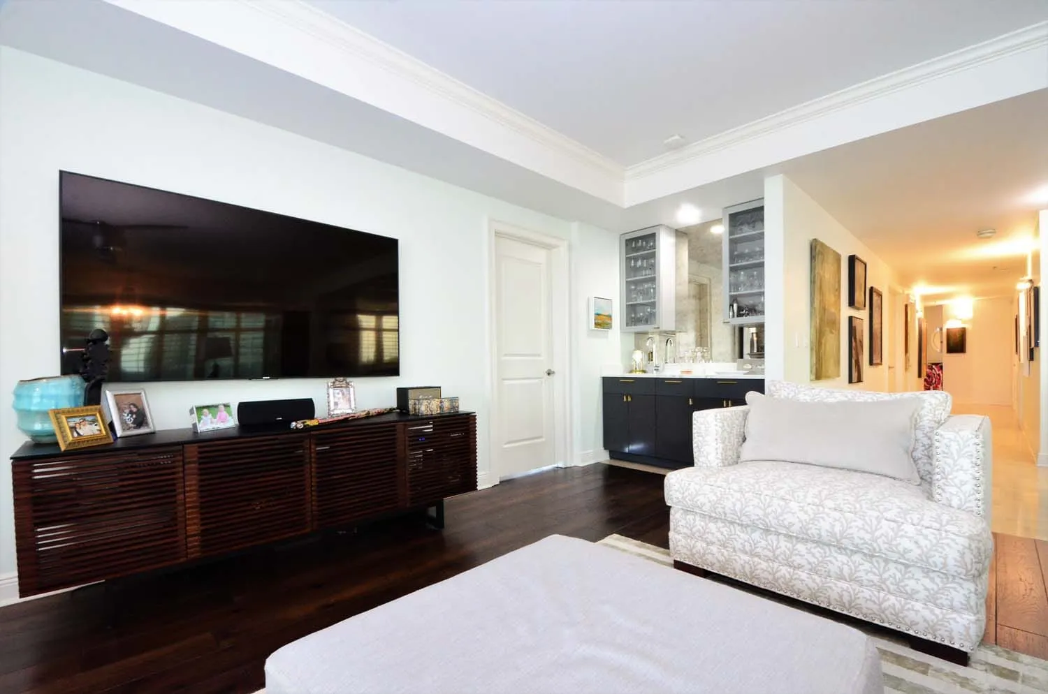 Living room with flat-screen TV and white furnishings