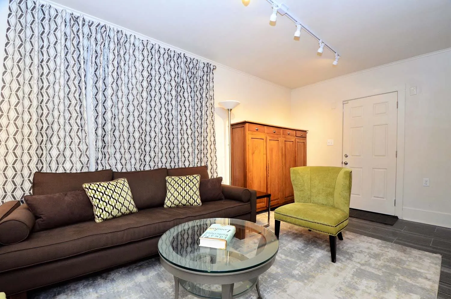 Living room with two sofas and green accent chairs