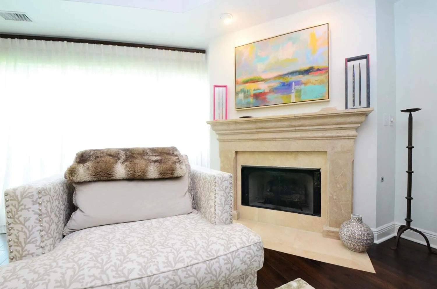 Sitting area beside the fireplace with original art above