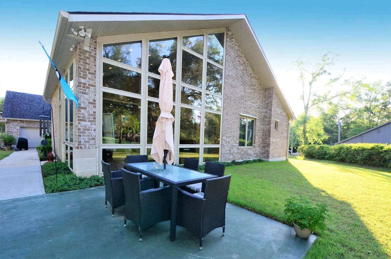 Back of the home with outdoor dining on the patio