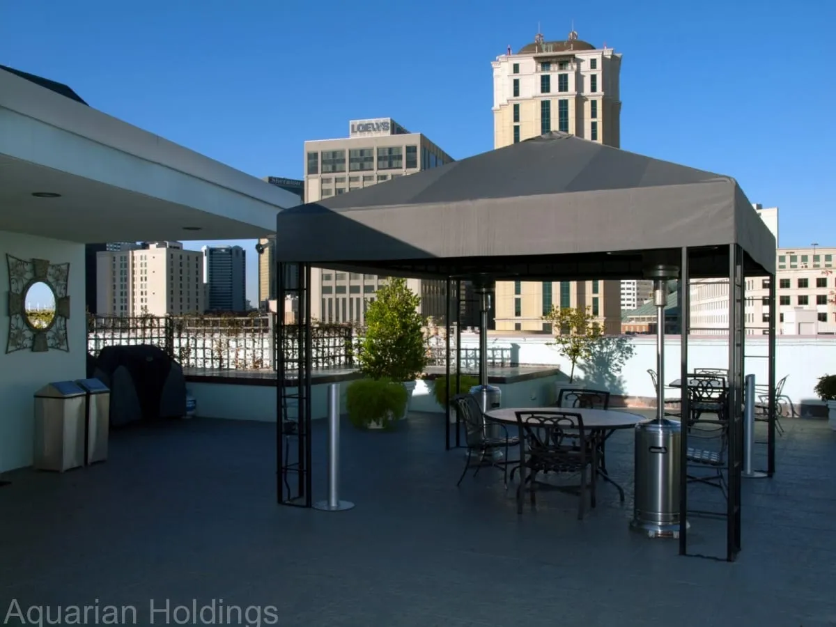 Rooftop entertainment area with covered seating and city views