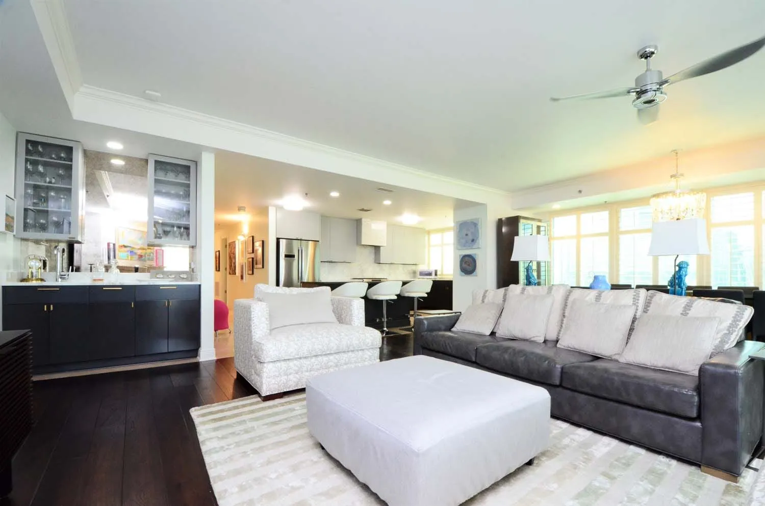 Open living area with white sectional and kitchen beyond