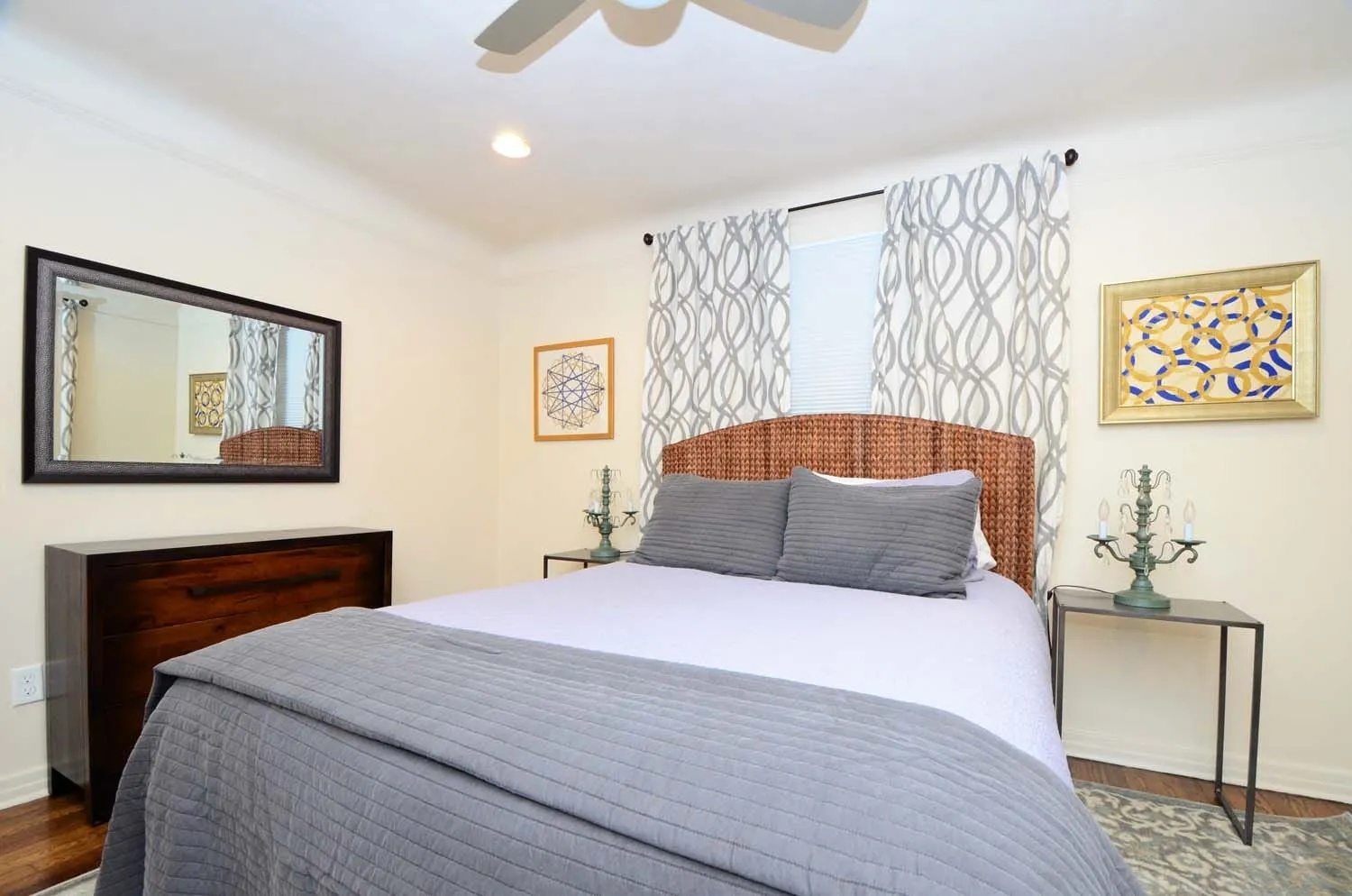 Bedroom with upholstered headboard and yellow accents