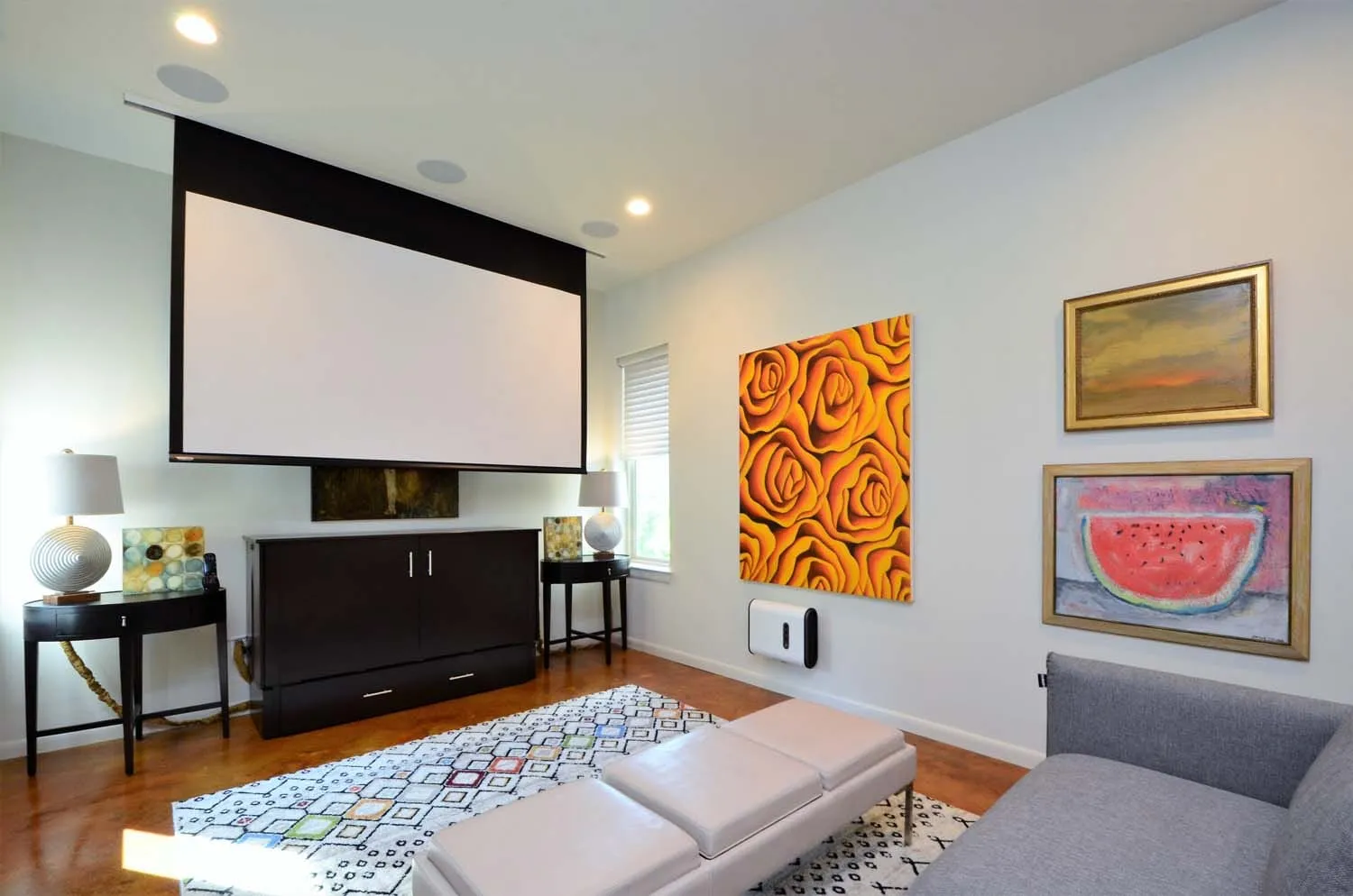 Media room with projection screen and original artwork
