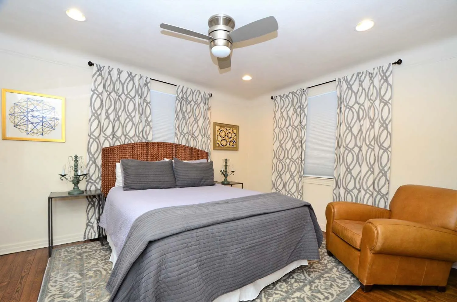 Bedroom with armchair and patterned curtains