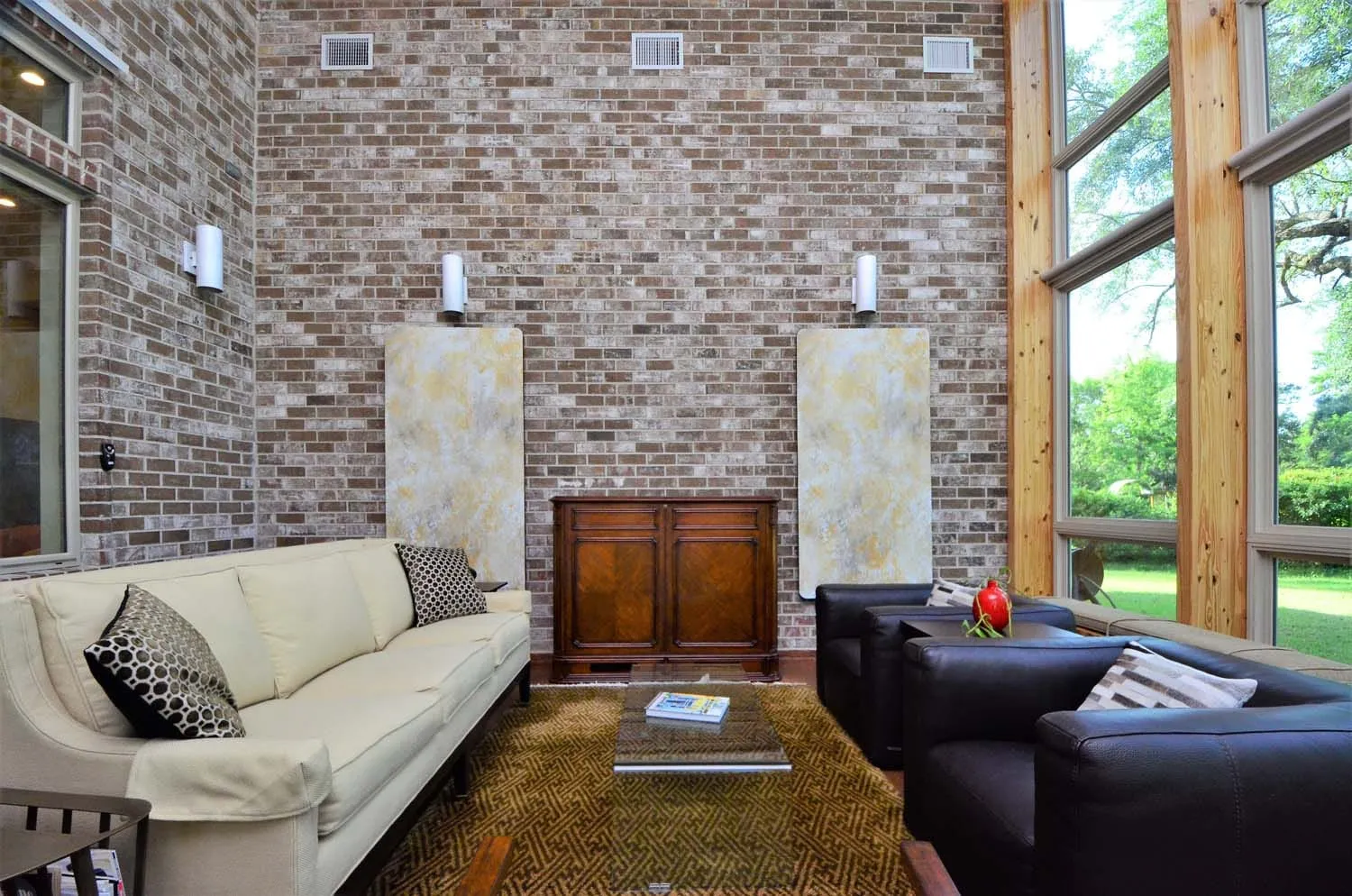 Den with stone fireplace wall and leather seating