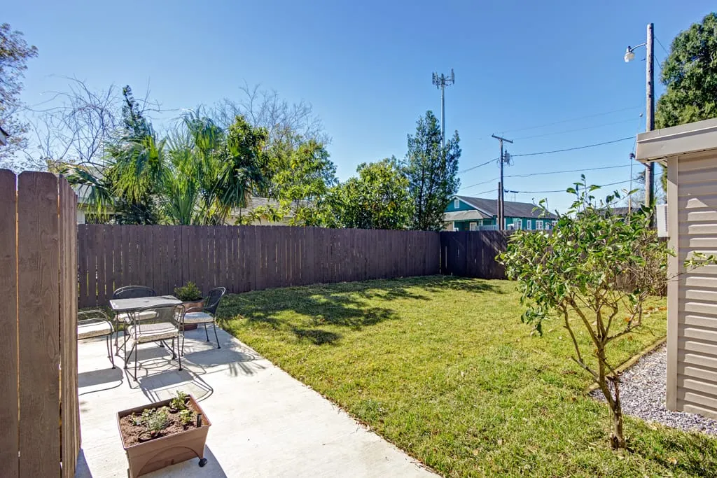 Fenced backyard with patio seating