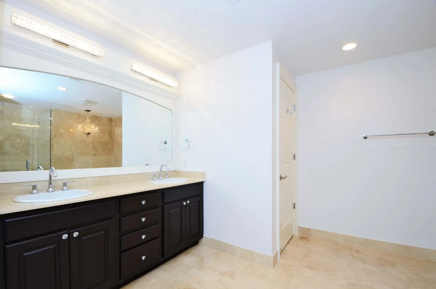 Bathroom with long double vanity and large mirror