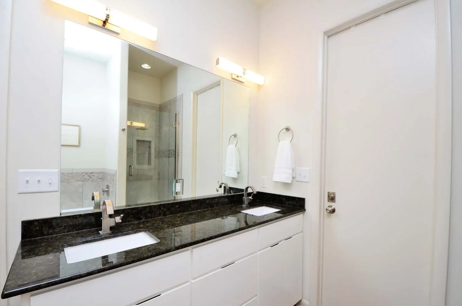 Double-vanity bathroom with black counters