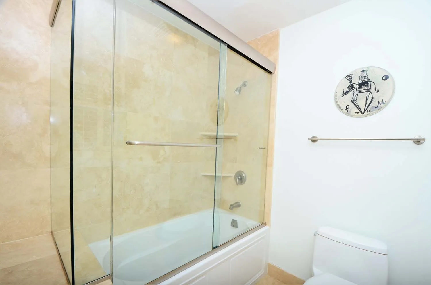 Bathroom with glass-front tub shower