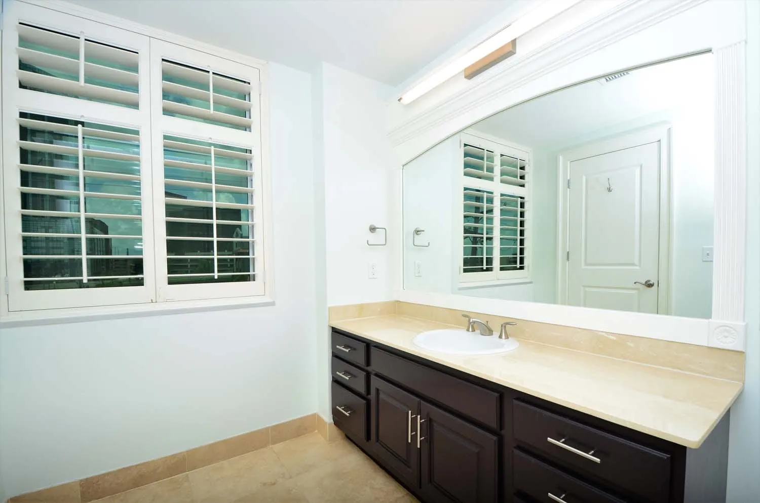 Bathroom vanity with window light and shutters